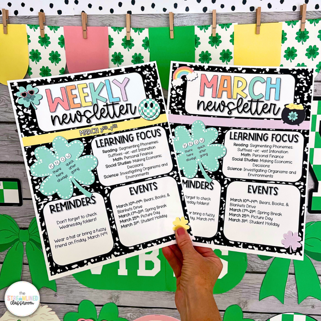 Hand holding both the weekly and March newsletter templates in front of a St. Patrick’s Day-themed classroom bulletin board.