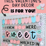 A pink and pastel-themed Valentine's Day classroom bulletin board featuring the phrase "I Knew You Were Sweet When You Walked In." The board is decorated with heart-shaped name tags, candy-themed illustrations, and a stylish black-and-white polka dot border. The text overlay reads, "Swiftie Teachers, This Valentine's Day Decor Is for You!" with playful fonts and pastel heart accents.