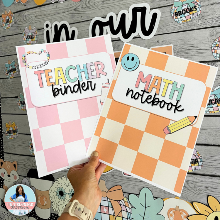 A teacher holding two printed binder covers, labeled “Teacher Binder” and “Math Notebook,” in pastel pink and orange checkerboard designs. A bulletin board with classroom decor is in the background.