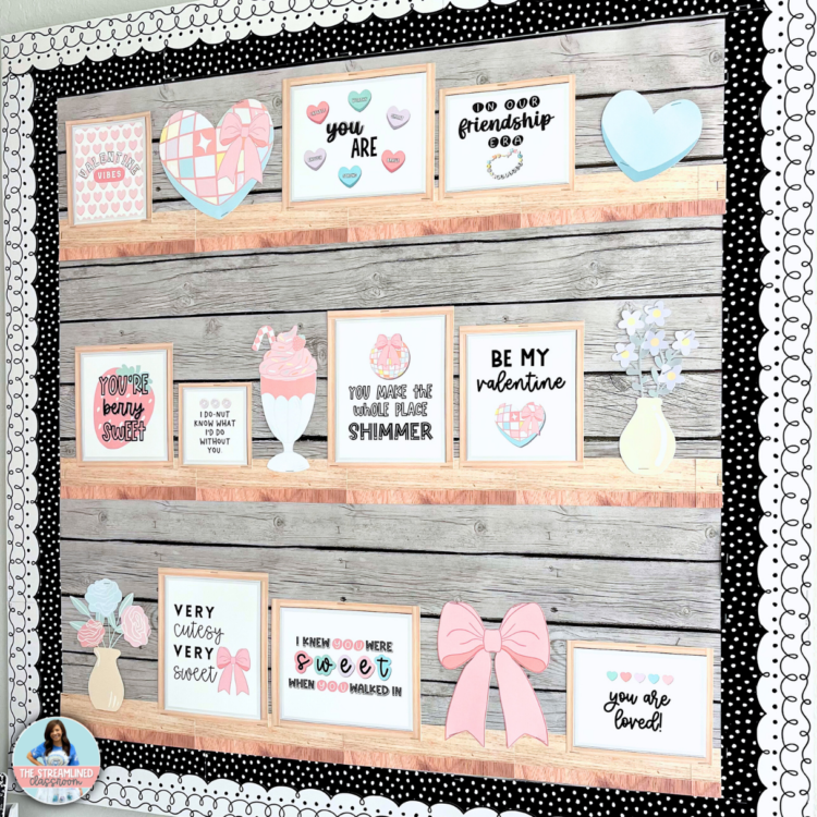 A real classroom bulletin board featuring framed Valentine’s quotes, pastel bows, and candy hearts arranged on wood-look printable shelves. The display has a black-and-white polka dot border for a stylish finish.