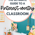 A bright and colorful classroom featuring a teal bulletin board decorated with smiley faces, rainbows, and retro-inspired decor. The desk area includes a lava lamp, a small potted plant, and rainbow-themed stationery. A large white circle overlay with bold text reads: "The Ultimate Guide to a Pinterest-Worthy Classroom," with a stylish mix of script and block fonts. The pin has a fun, inviting aesthetic perfect for teachers looking for classroom decor inspiration.