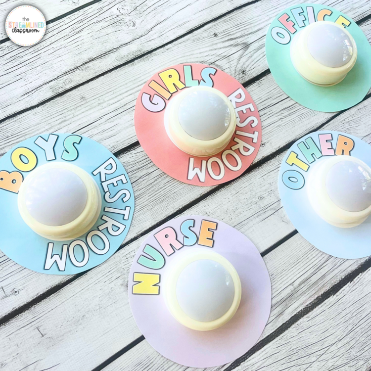 Pastel classroom push light hall passes labeled Boys' Restroom, Girls' Restroom, Nurse, Office, and Other, displayed on wooden background.